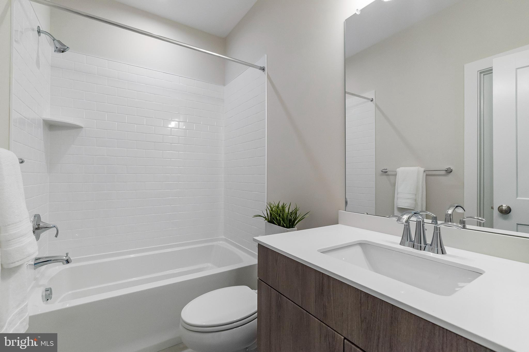 7 Mainland Road, Unit 102 Harleysville, PA 19438 - Photo 3 of 30 a bathroom with a granite countertop sink toilet and shower