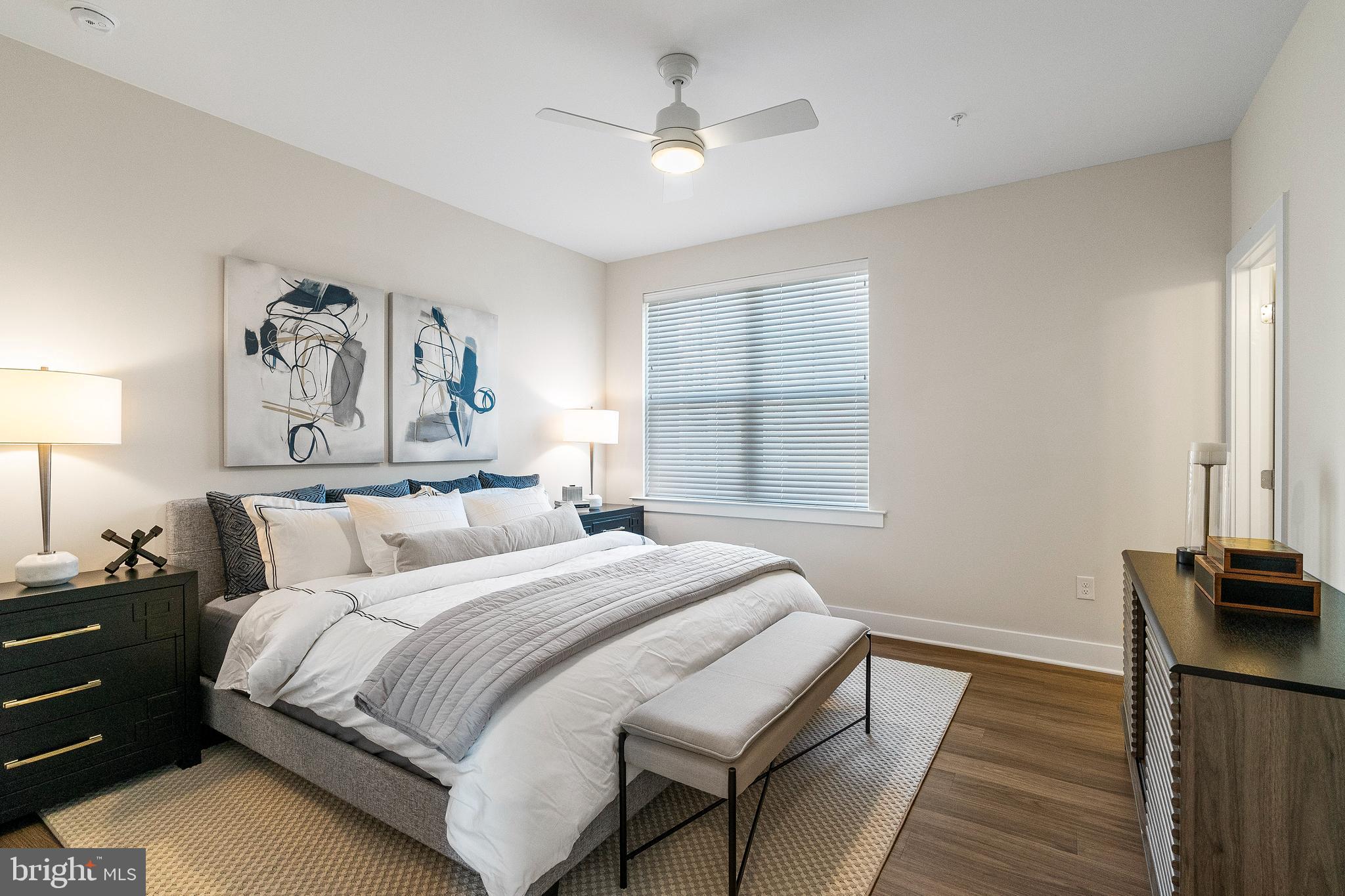 7 Mainland Road, Unit 102 Harleysville, PA 19438 - Photo 7 of 30 a bedroom with a bed and a painting on the wall