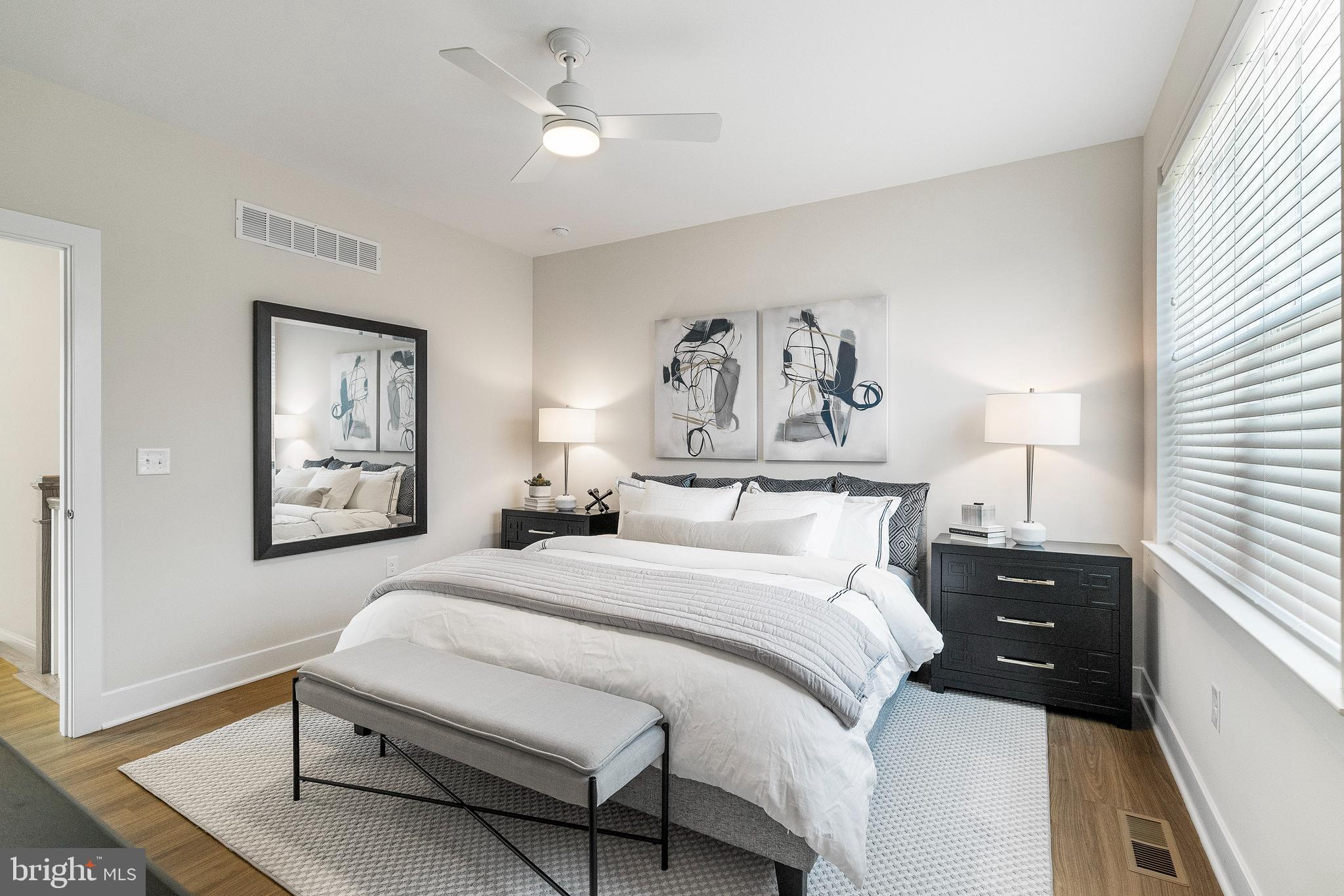 7 Mainland Road, Unit 102 Harleysville, PA 19438 - Photo 8 of 30 a bedroom with a bed and a chandelier