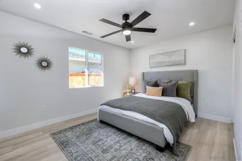 a bedroom with a bed and a chandelier