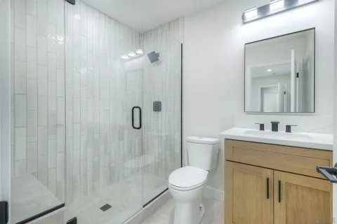 a kitchen with stainless steel appliances kitchen island granite countertop a stove a sink a refrigerator a dining table and chairs with wooden floor