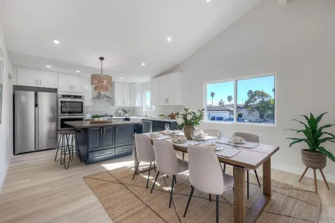 a kitchen with stainless steel appliances granite countertop a sink a stove a refrigerator and island with wooden floor