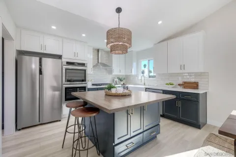 a kitchen with stainless steel appliances kitchen island granite countertop a stove microwave and sink