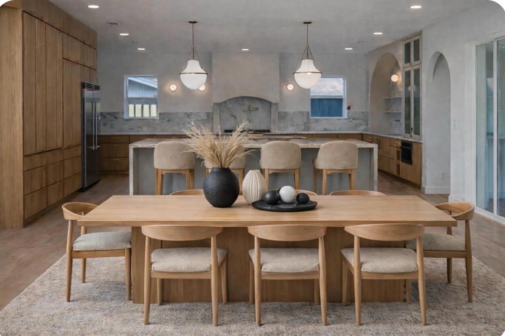 3341 Dothan Lane Dallas, TX 75229 - Photo 2 of 13 a kitchen with a dining table chairs stainless steel appliances and cabinets