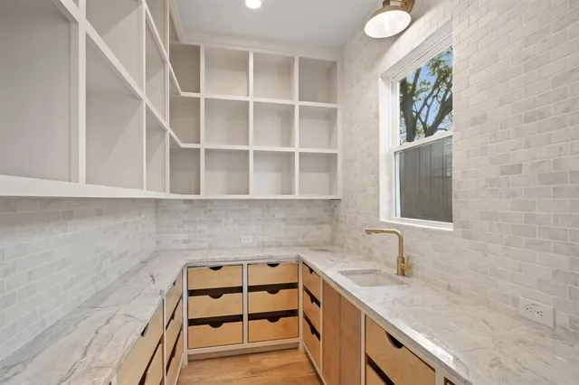 a kitchen with a sink and cabinets