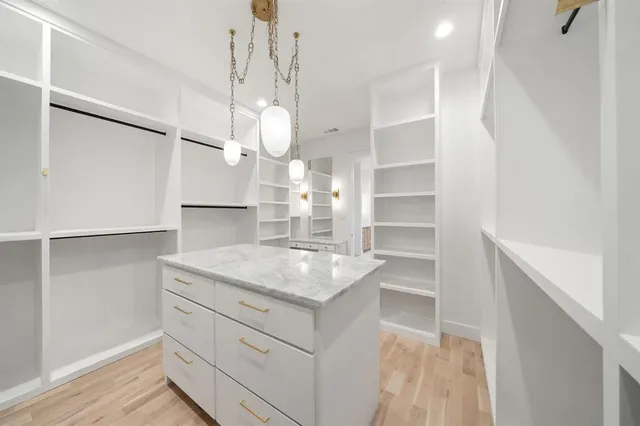 a kitchen with a sink dishwasher a stove and a refrigerator with wooden floor