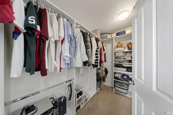 a living room with furniture flat screen tv and large window
