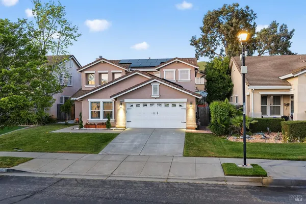 an aerial view of a city with lots of residential buildings ocean and mountain view in back