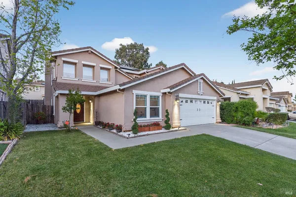 a kitchen with stainless steel appliances granite countertop a stove top oven a sink dishwasher a dining table and chairs with wooden floor