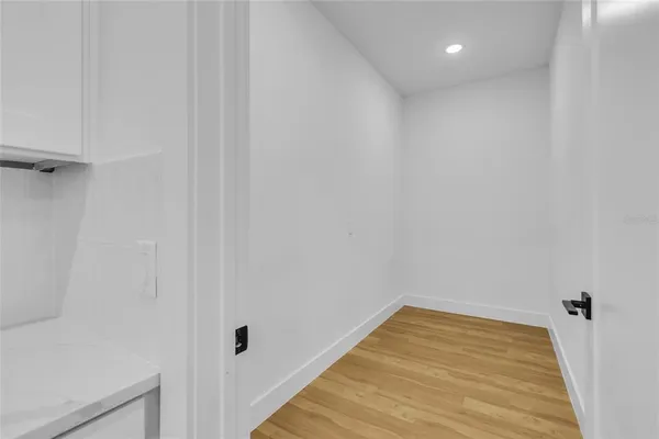 a view of a room with wooden floor