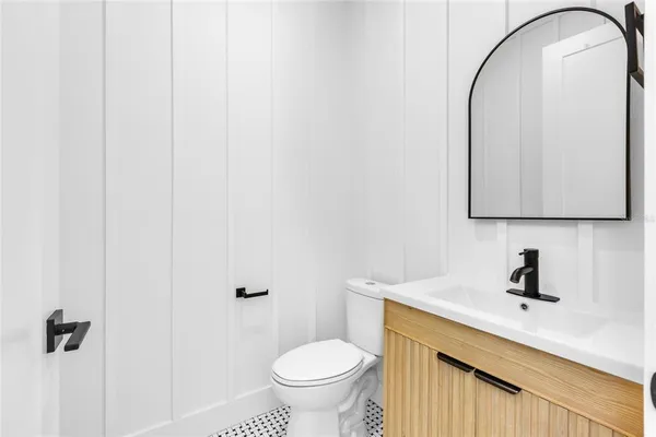 a bathroom with a toilet a sink and mirror