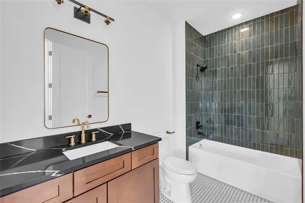 a bathroom with a sink a toilet and bathtub