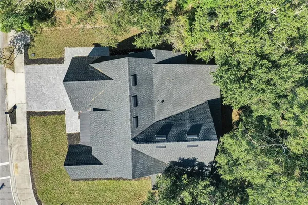 an aerial view of a house with yard