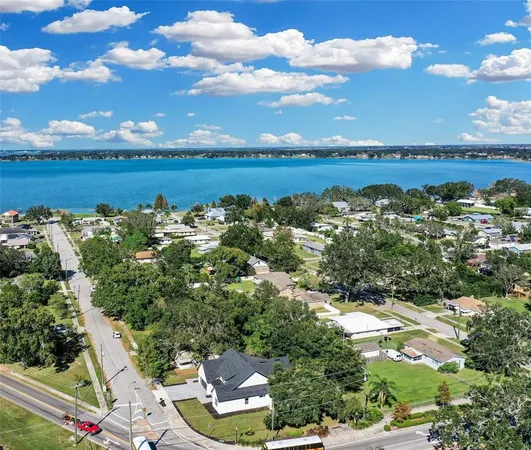 a view of a city with lots of residential buildings ocean and mountain view in back
