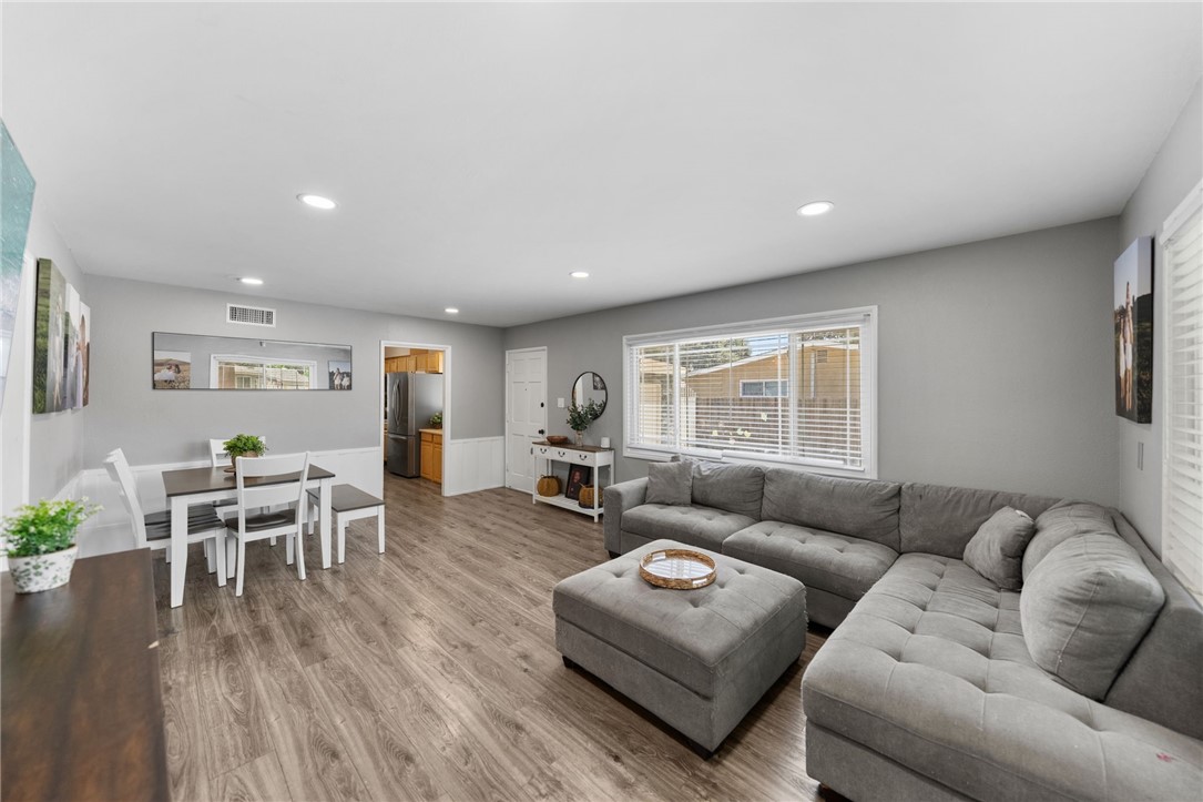 4869 Serrano Place Riverside, CA 92504 - Photo 16 of 40 Bright and open living space featuring recessed lighting, large windows for natural light, and attractive wood-look flooring that creates a warm and inviting atmosphere.