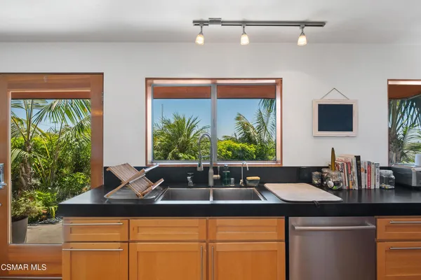 a kitchen with a sink and large window