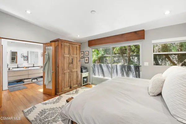 a bedroom with a large bed and a large window
