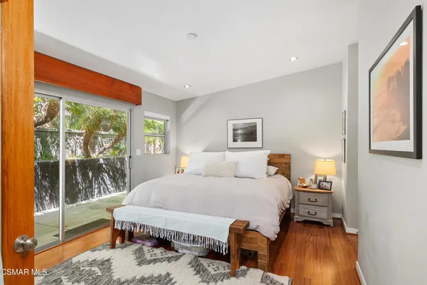 a bedroom with a bed and large window with outer view