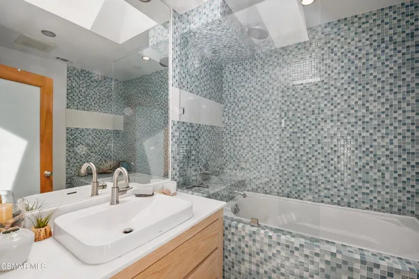 a bathroom with a bathtub and sink