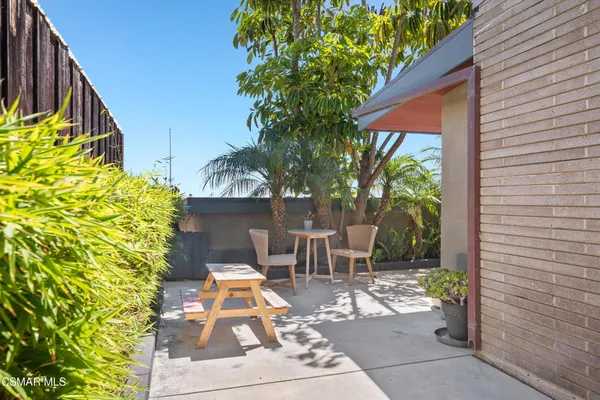 a view of a patio with table and chairs and potted plants
