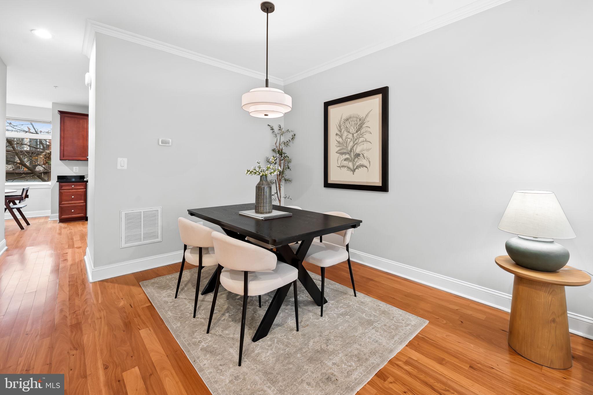 1024 Pier Pointe Landing, Unit 107 Baltimore, MD 21230 - Photo 15 of 51 a view of a dining room with furniture and wooden floor