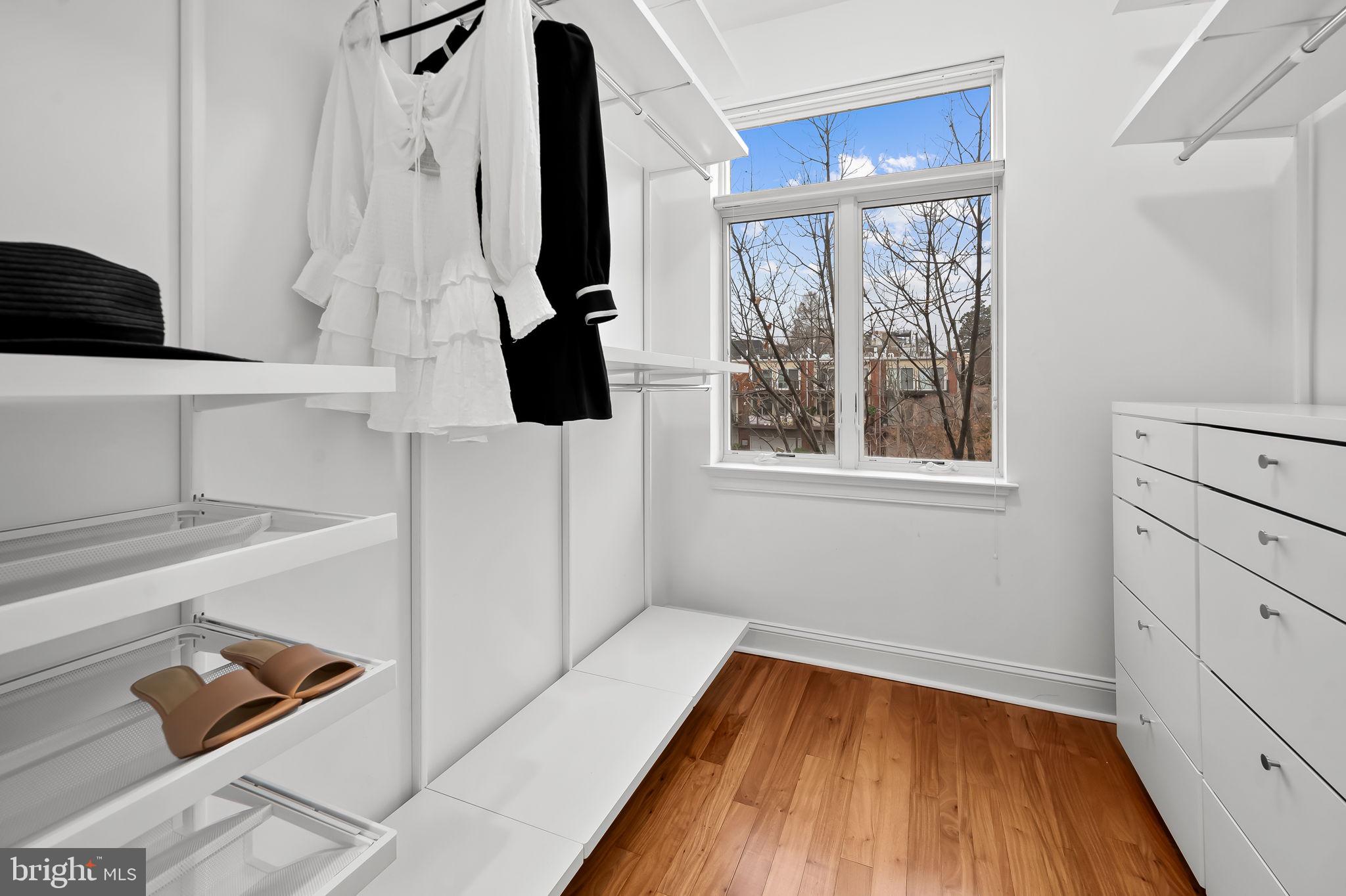 1024 Pier Pointe Landing, Unit 107 Baltimore, MD 21230 - Photo 21 of 51 a view of walk in closet with clothes and shoes