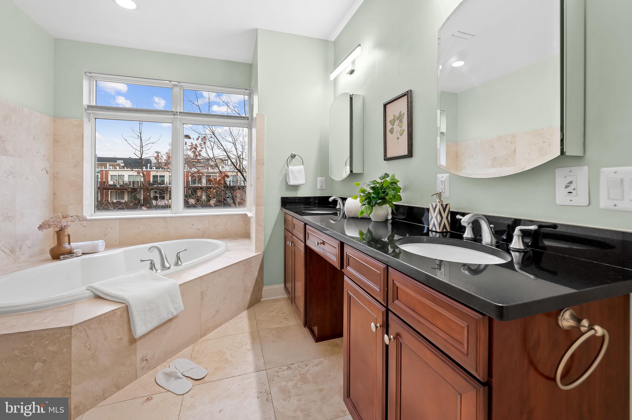 1024 Pier Pointe Landing, Unit 107 Baltimore, MD 21230 - Photo 22 of 51 a spacious bathroom with a granite countertop tub sink and mirror