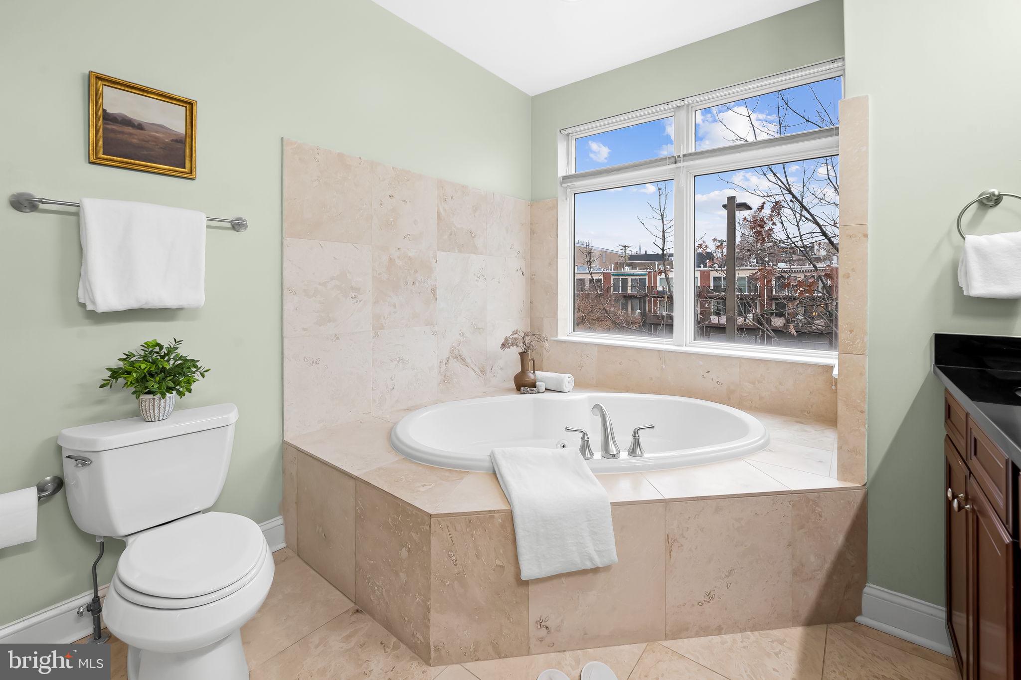 1024 Pier Pointe Landing, Unit 107 Baltimore, MD 21230 - Photo 23 of 51 a white bath tub sitting next to a white toilet