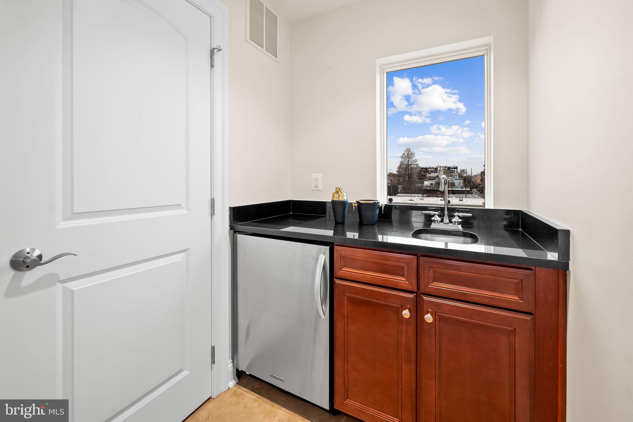 1024 Pier Pointe Landing, Unit 107 Baltimore, MD 21230 - Photo 32 of 51 a kitchen with a sink and a refrigerator