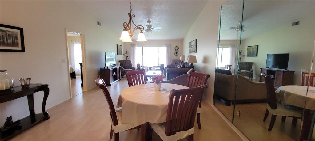 3505 Tarpon Woods Boulevard, Unit P408 Palm Harbor, FL 34685 - Photo 11 of 22 a view of a dining room with furniture and chandelier