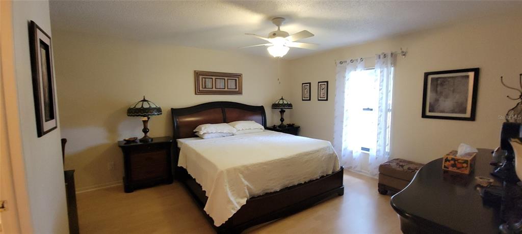 3505 Tarpon Woods Boulevard, Unit P408 Palm Harbor, FL 34685 - Photo 17 of 22 a bedroom with a bed and a chandelier