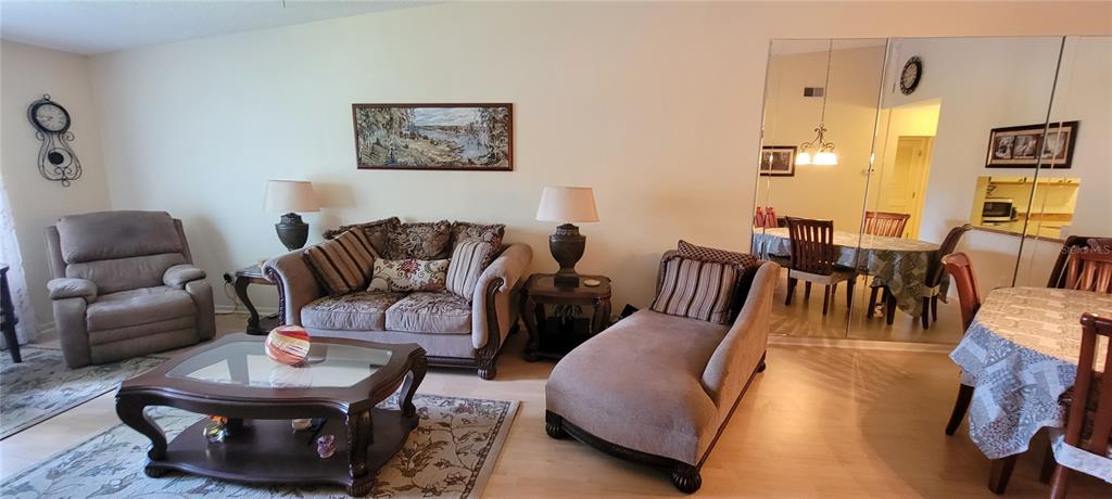 3505 Tarpon Woods Boulevard, Unit P408 Palm Harbor, FL 34685 - Photo 20 of 22 a living room with furniture and wooden floor