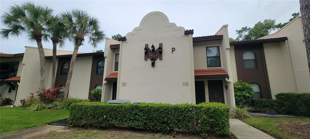 3505 Tarpon Woods Boulevard, Unit P408 Palm Harbor, FL 34685 - Photo 2 of 22 a front view of a house with garden