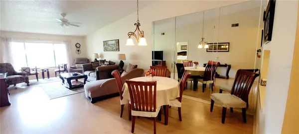 a living room with furniture dining area and a window