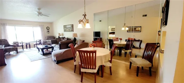 a living room with furniture dining area and a window