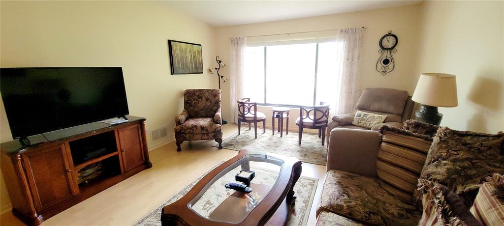 3505 Tarpon Woods Boulevard, Unit P408 Palm Harbor, FL 34685 - Photo 8 of 22 a living room with furniture and a flat screen tv