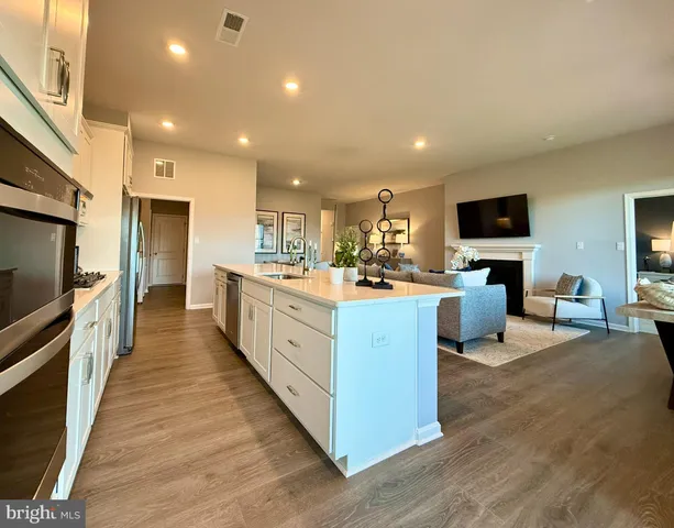 a large kitchen with stainless steel appliances lots of counter top space