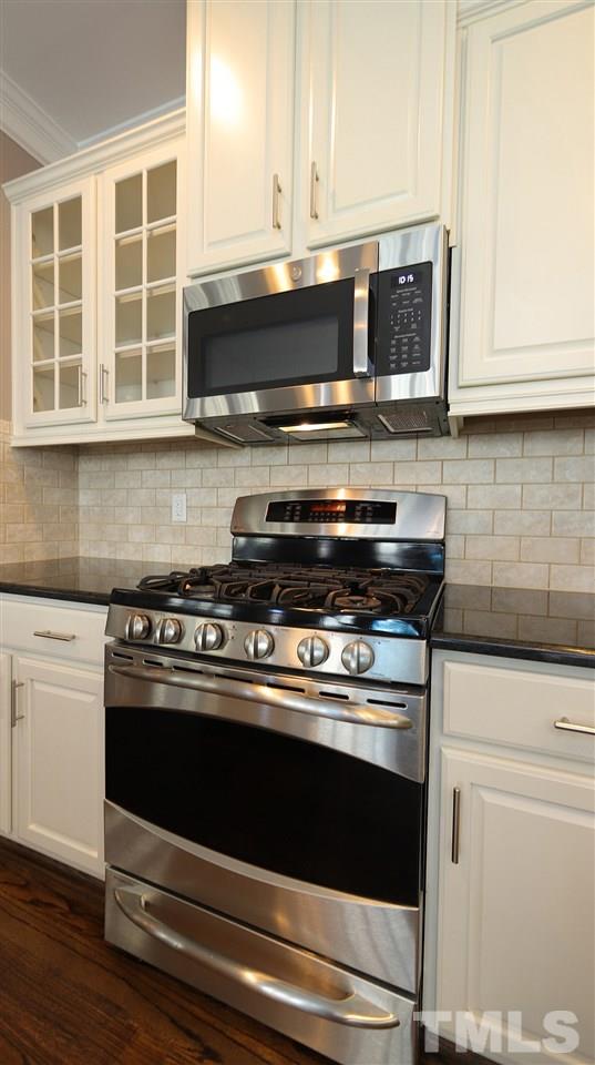 1541 Fullerton Place Raleigh, NC 27607 - Photo 11 of 29 a stove top oven sitting inside of a kitchen