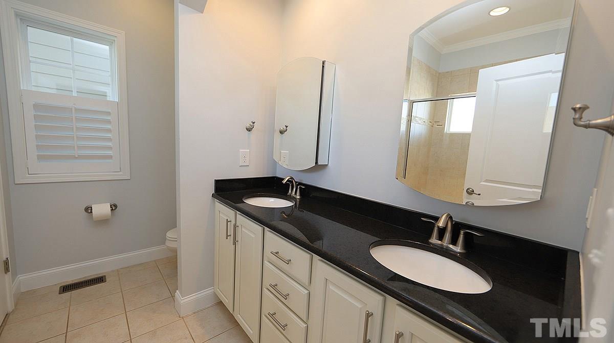 1541 Fullerton Place Raleigh, NC 27607 - Photo 15 of 29 a bathroom with a granite countertop sink and a mirror