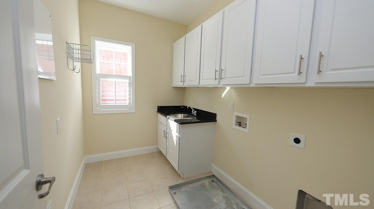 1541 Fullerton Place Raleigh, NC 27607 - Photo 17 of 29 a view of storage and utility room with a fridge