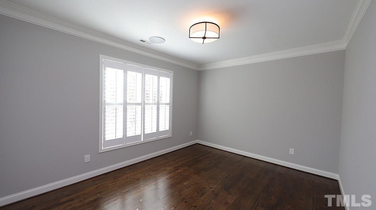 1541 Fullerton Place Raleigh, NC 27607 - Photo 4 of 29 an empty room with wooden floor and windows