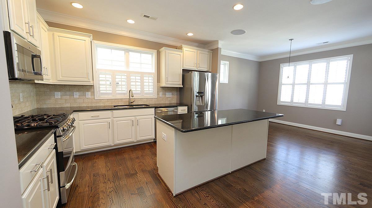 1541 Fullerton Place Raleigh, NC 27607 - Photo 6 of 29 a kitchen with stainless steel appliances granite countertop a sink a stove a refrigerator cabinets and a window