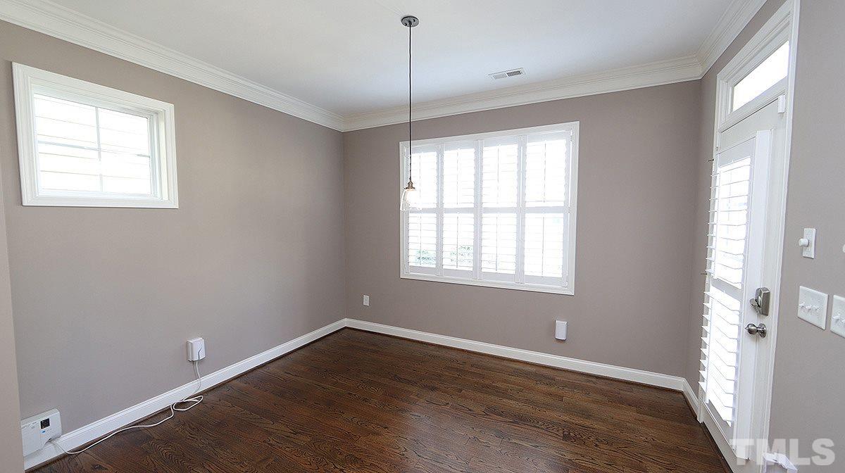 1541 Fullerton Place Raleigh, NC 27607 - Photo 8 of 29 a view of an empty room with wooden floor and a window