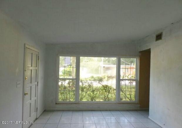 7022 Rollo Road Jacksonville, FL 32205 - Photo 3 of 10 a view of an empty room and window