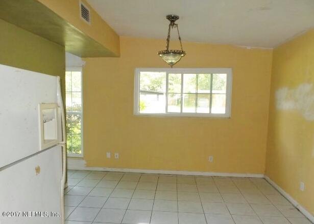 7022 Rollo Road Jacksonville, FL 32205 - Photo 5 of 10 a view of an empty room with a window