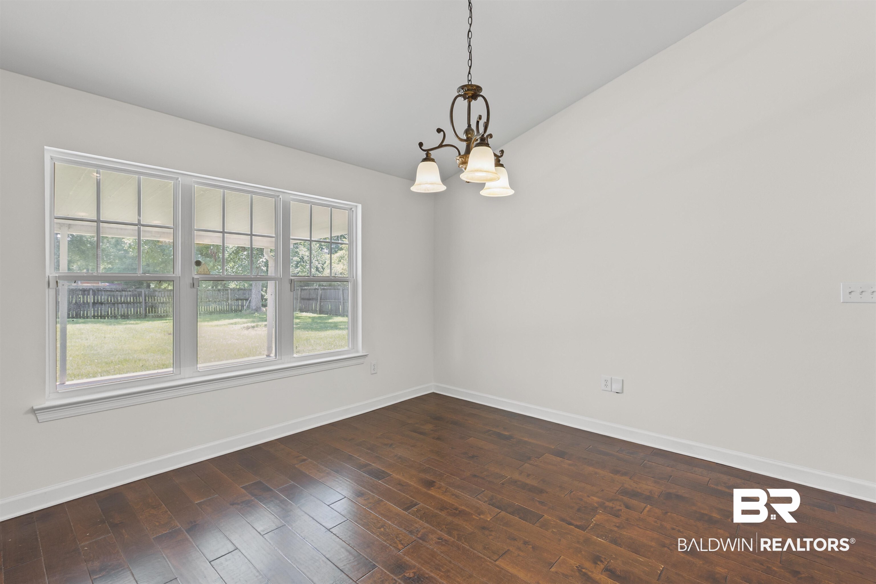 924 Brady Road North Bay Minette, AL 36507 - Photo 11 of 26 Spare room with a chandelier and dark wood-type flooring