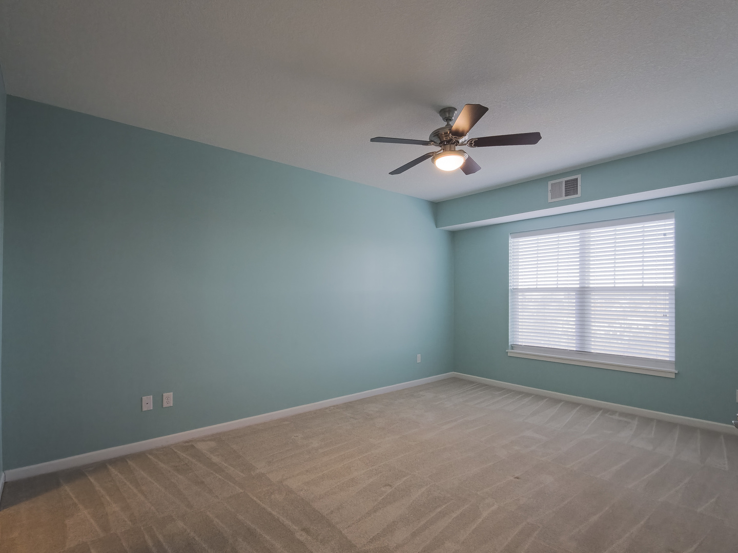 2592 Middle Road, Unit 313 Bettendorf, IA 52722 - Photo 31 of 52 an empty room with a window and a fan