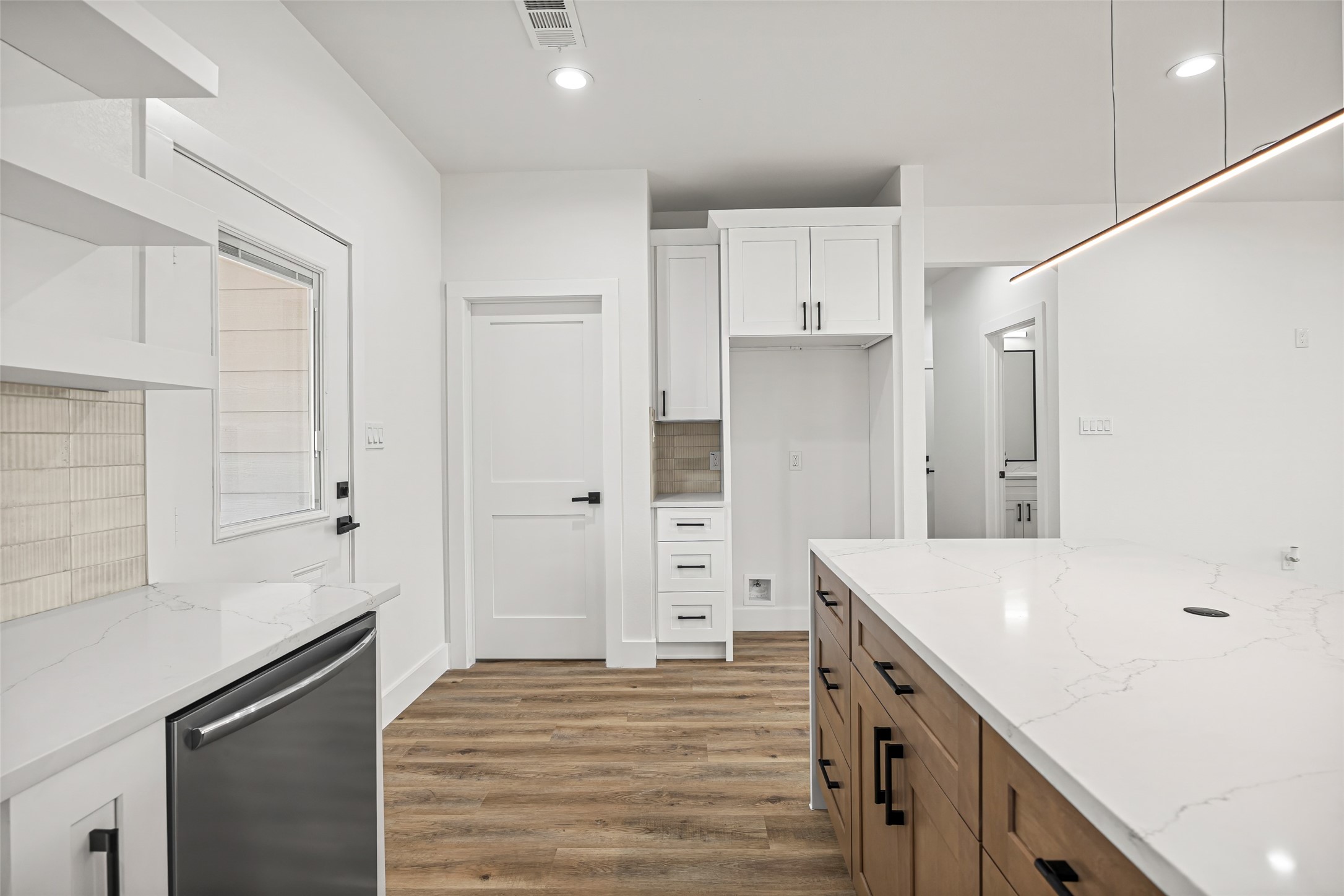 1807 Waco Street Dayton, TX 77535 - Photo 9 of 26 Custom cabinetry with built-in storage, designated refrigerator space, and nearby pantry access.