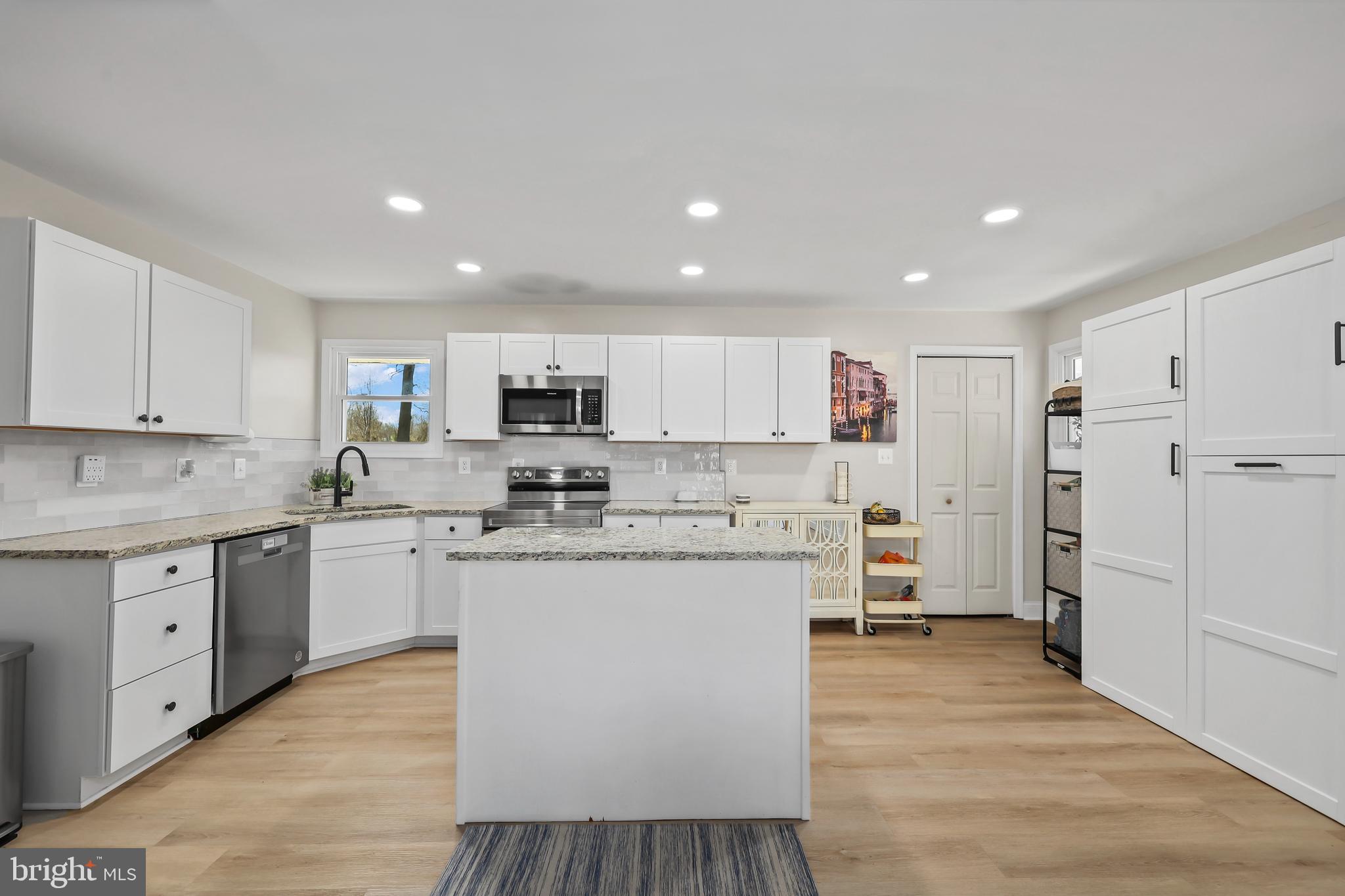 379 Ferry Road Fredericksburg, VA 22405 - Photo 11 of 33 a kitchen with cabinets and wooden floor