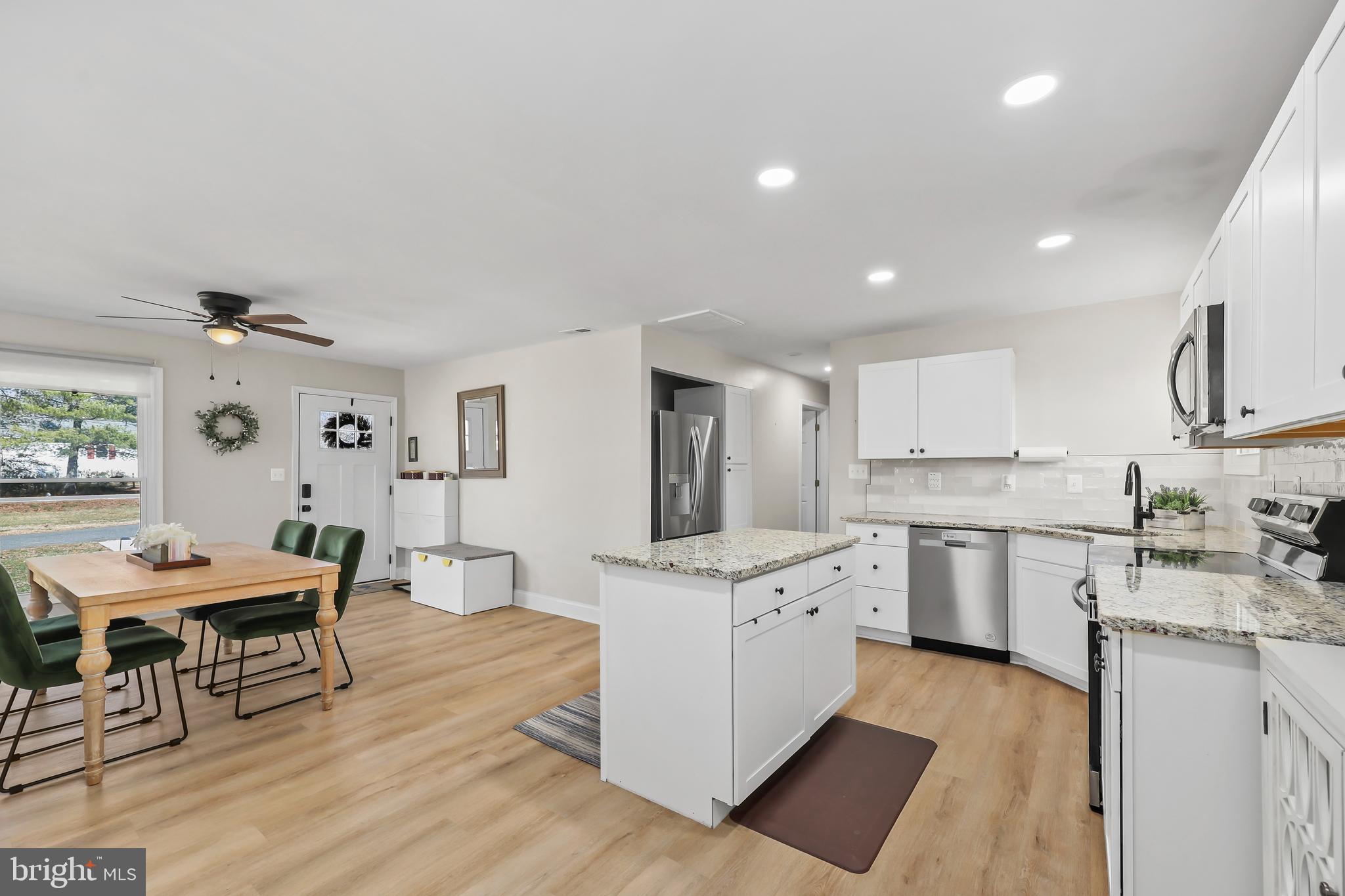 379 Ferry Road Fredericksburg, VA 22405 - Photo 12 of 33 a large kitchen with stainless steel appliances kitchen island granite countertop a large island in the center